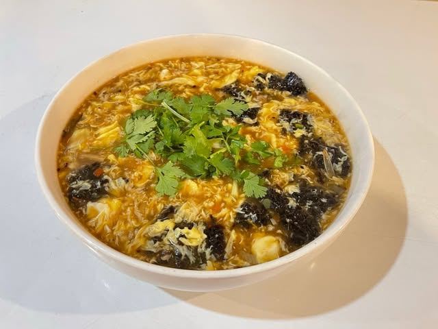 Hot and sour soup with egg, wood ear mushroom, tofu and cilantro